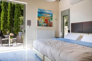 A bed or beds in a room at Aloni Villa - Contemporary Villa with Private Pool & Sea Views, Fiskardo
