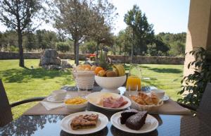 a table with plates of food on top of it at Hotel Nibaru in Porto Cervo