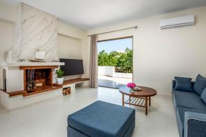 a living room with a blue couch and a fireplace at City apartment in Rhodes Town