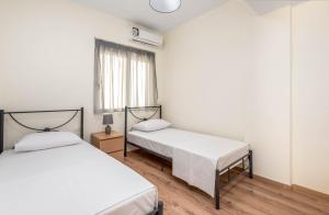 a bedroom with two beds and a window at City apartment in Rhodes Town