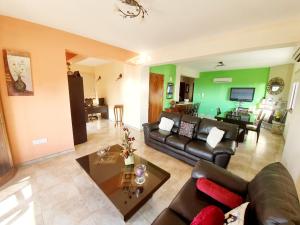 a living room with a couch and a table at JOANNA SUNSET APTS Pomos in Pomos
