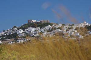 a group of white houses on top of a hill at Effie Hotel in Skala
