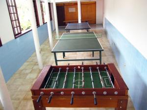 two ping pong tables in a room with two tables at Pousada das Rosas in Miguel Pereira +21 photos