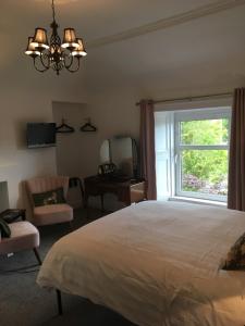 a bedroom with a large bed and a window at Room Only Corbies Rest in Inverness
