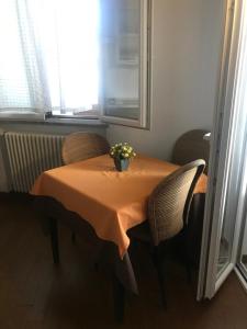 モンデッロにあるb&b Simpatyのテーブルと椅子、花瓶