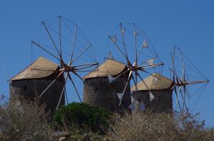 a group of windmills sitting on top of a hill at Effie Hotel in Skala