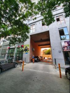 a man standing outside of a building with a garage at 5 Rooms near 300 Aragveli metro station in Tbilisi City
