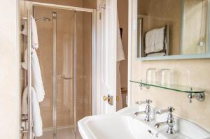 a bathroom with a sink and a shower at Beera Farmhouse in Milton Abbot +33 photos