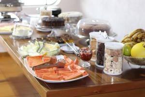 a table with a bunch of food on it at Hotel Turi in Barra Bonita