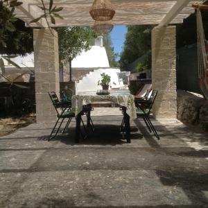 a table and two chairs on a patio at Trullo Degli Ulivi in Ostuni