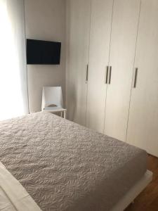 a bedroom with a large bed and white cabinets at Le Piazzette Schio in Schio