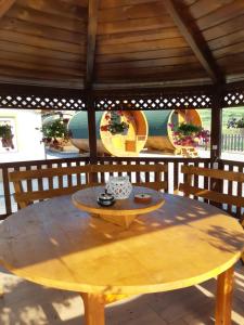 a wooden table in a pavilion with a yellow table at Cazare tudor&abril in Cojocna +16 photos