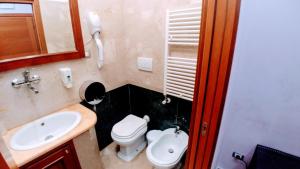 a bathroom with a white toilet and a sink at Affittacamere Stranamore in Frascati