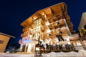 a large building in the snow at night at Appartementhaus Kristall at SchattbergXpress by All in One Apartments in Saalbach-Hinterglemm