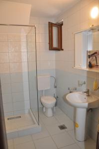 a bathroom with a toilet and a sink at Apartments Ravno in Plužine