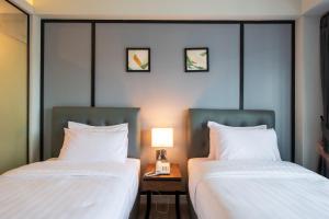 Postel nebo postele na pokoji v ubytování Mayson Place Hotel