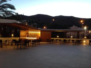 a group of tables and chairs outside of a building at Hotel Santamarta in Cullera