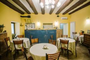 a restaurant with tables and chairs and a kitchen at Mariam R in Tbilisi City