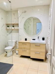 a bathroom with a toilet and a sink and a mirror at L'Escale au Coeur du Vieux Port de Marseille in Marseille +25 photos
