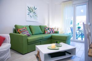 a living room with a green couch and a table at Mihail in Nikiti +25 photos