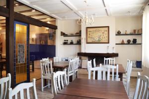 a dining room with a table and chairs and a fireplace at HOSTAL RESTAURANTE SAN ISIDRO in Quintanar de la Orden