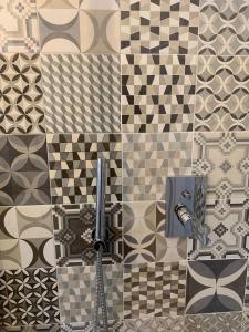 a bathroom with a sink and a tile wall at Appartamenti San Pietro in Perugia