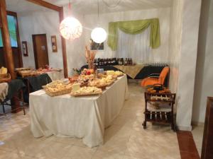 a table with a buffet of food in a room at Pousada das Rosas in Miguel Pereira