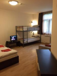 a room with two bunk beds and a television at VIVA Flora apartment 607A in Borovets