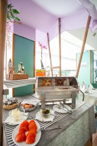 a table topped with plates of pastries on a table at Hotel Nevada in Bellaria-Igea Marina