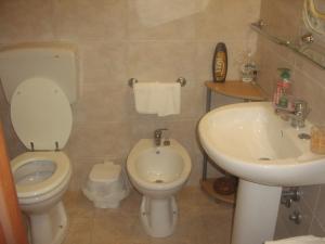 a bathroom with a toilet and a sink at B&B Valoroso Village in Licata