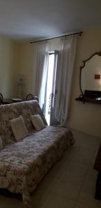 a bedroom with a bed and a mirror on the wall at la fontanella in Militello in Val di Catania