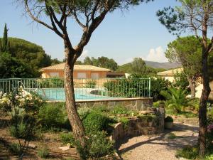 a villa with a swimming pool in a garden at Mas Aurélia B&B in Fréjus