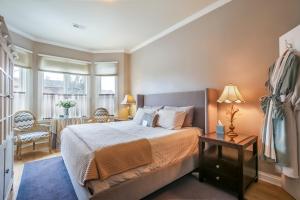 a bedroom with a large bed and a table at Harvey House Bed & Breakfast in Oak Park