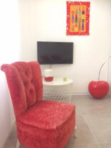Televízia a/alebo spoločenská miestnosť v ubytovaní Casa4Casa