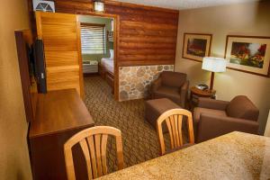 a living room with a couch, chair and a television at Holiday Inn Express Grand Canyon, an IHG Hotel in Tusayan
