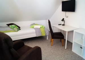 1 dormitorio con cama, escritorio y silla en Ferienzimmer Segeberg en Bad Segeberg