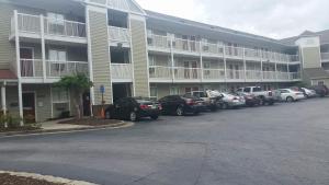 a parking lot in front of a large apartment building at InTown Suites Extended Stay Atlanta GA - Douglasville in Douglasville