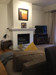 a living room with a couch and a fireplace at Casares Village Bed & Breakfast in Casares