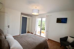 a bedroom with a bed and a large window at La Dolce Vita Opio in Opio
