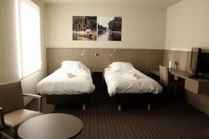 En eller flere senger på et rom på Hotel Otus
