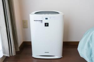 a white water cooler sitting in a room at Dazaifu - Apartment / Vacation STAY 36932 in Dazaifu
