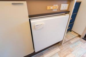 a refrigerator in a kitchen with a counter top at Dazaifu - Apartment / Vacation STAY 36647 in Dazaifu