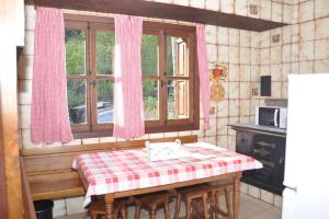a kitchen with a table with a checkered table cloth at La Casa de Sabina in Lon +25 photos