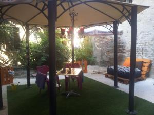 a gazebo with a table and chairs in a yard at Scotty's Boutique Hotel in Sofia
