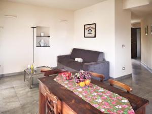 a living room with a table and a couch at Appartamento deluxe con terrazza sul mare in Savona