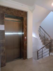 a elevator in a building with a staircase at GÜMÜLDÜR ÇALIŞKAN APART 1 in Gumuldur