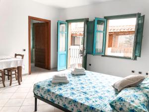 - une chambre avec un lit et des serviettes dans l'établissement S'Aposentu, à Muravera