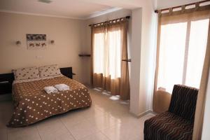 a bedroom with a bed and a chair at Rincon Secreto in San Rafael +70 photos