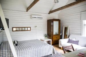 a bedroom with a bed and a couch at Westergårds in Föglö