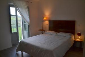 a bedroom with a bed and a large window at B&B Casale Fonte Vecchia in Monteprandone